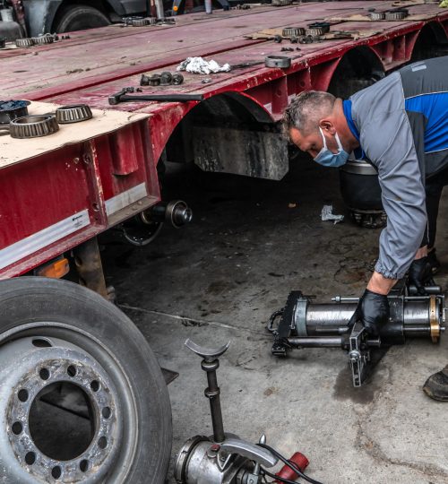 Meccanico lavora su un rimorchio di camion.